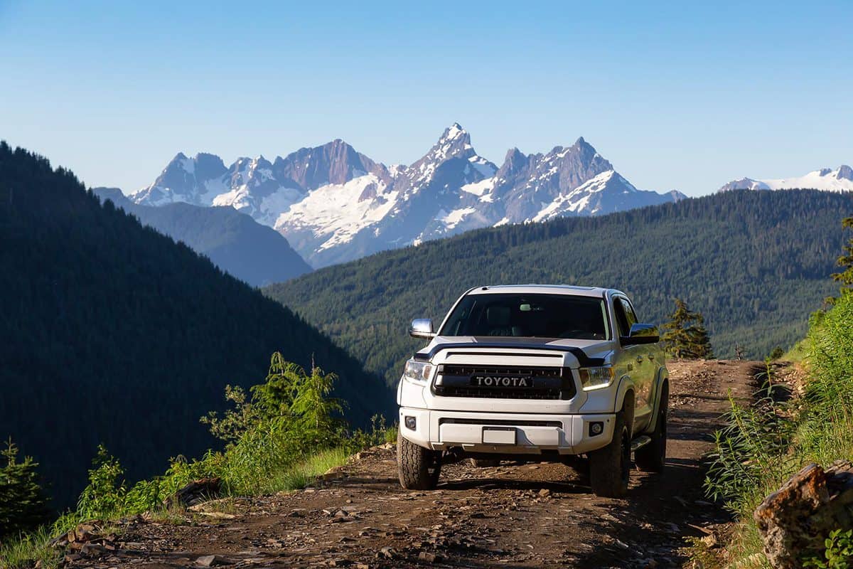 Toyota Tacoma riding on the 4x4 Offroad Trails in the mountains during a sunny summer morning