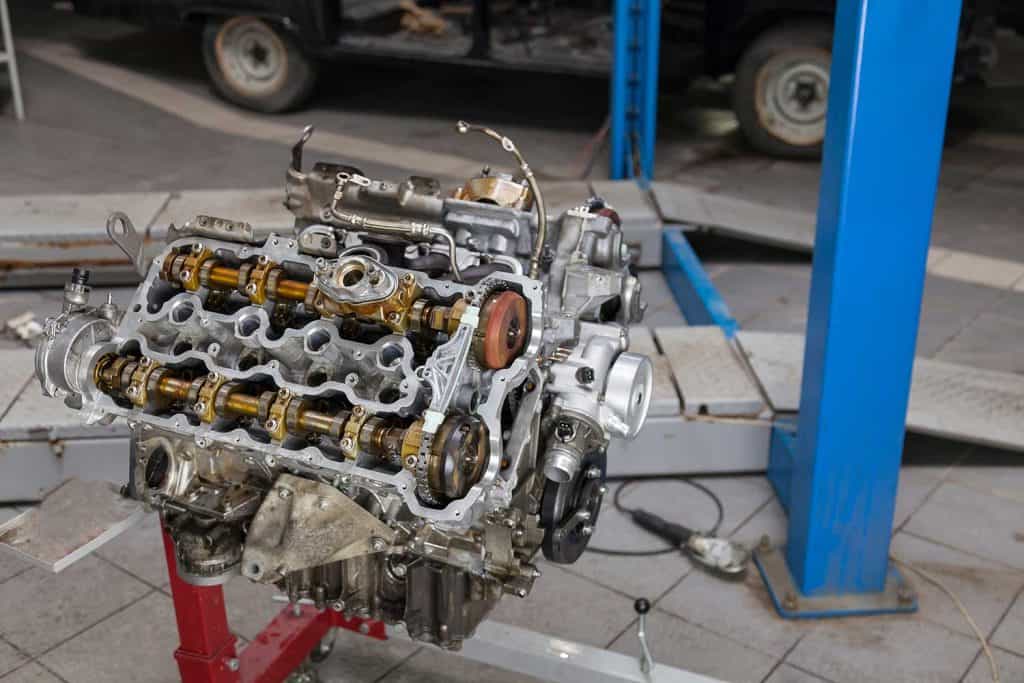 Used v8 engine mounted on a crane for installation on a car after a breakdown