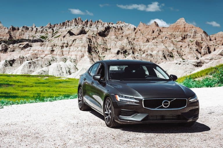 View of the new Volvo S60 T6 coupe parked on the road with the Badlands National Park in the background, Can You Get A Volvo Oil Change Anywhere?