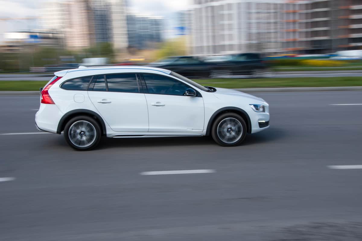 White Volvo V60 Cross Country car moving on the street