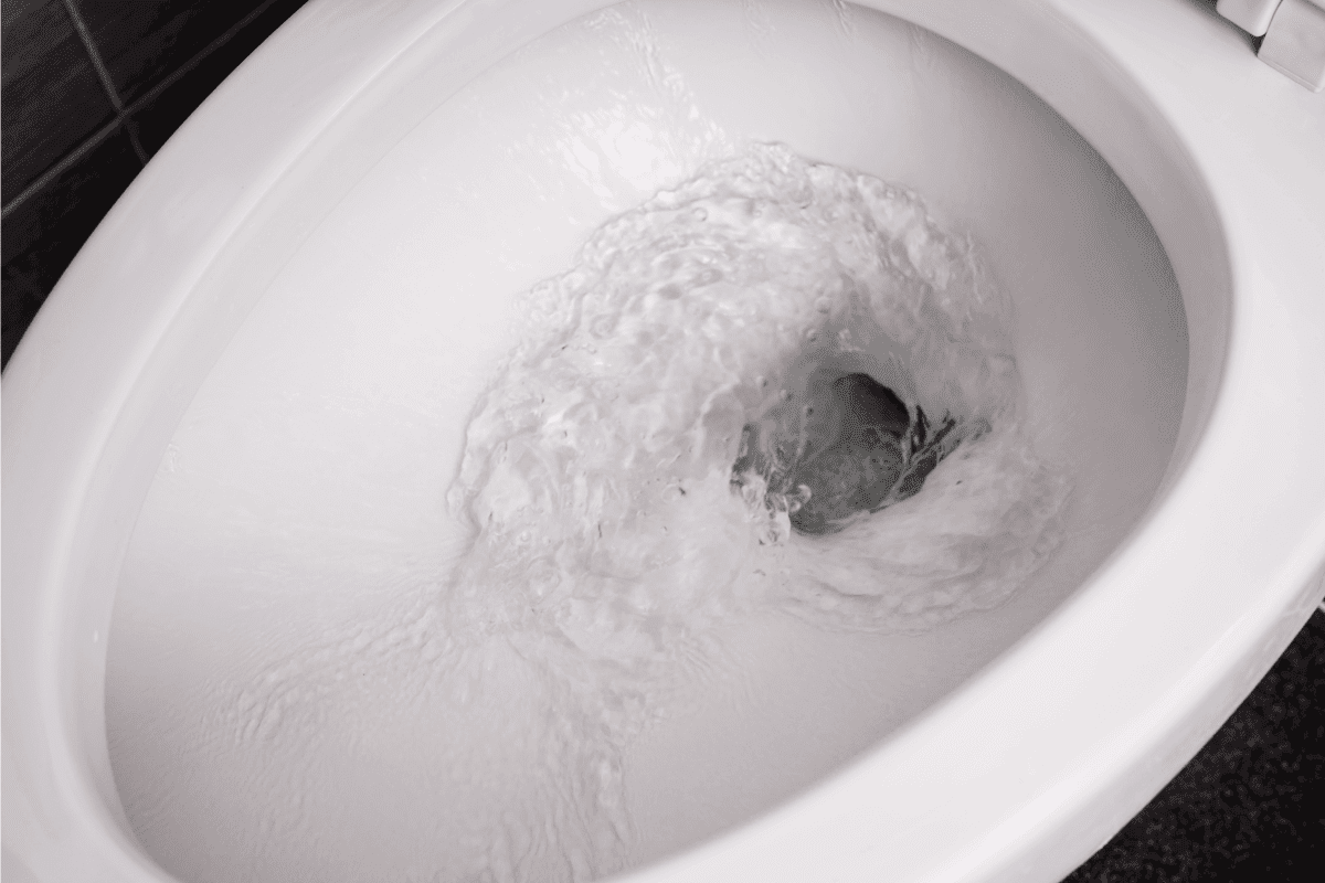 close up flushing water in toilet bowl. Should You Keep Water In An RV Toilet