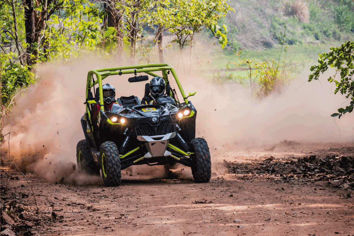 driver with co driver driving a UTV on a dirt track. 4 Best Toy Haulers For A Can-Am Maverick X3