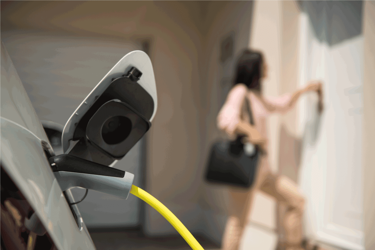 electric car charger with female silhouette in the background