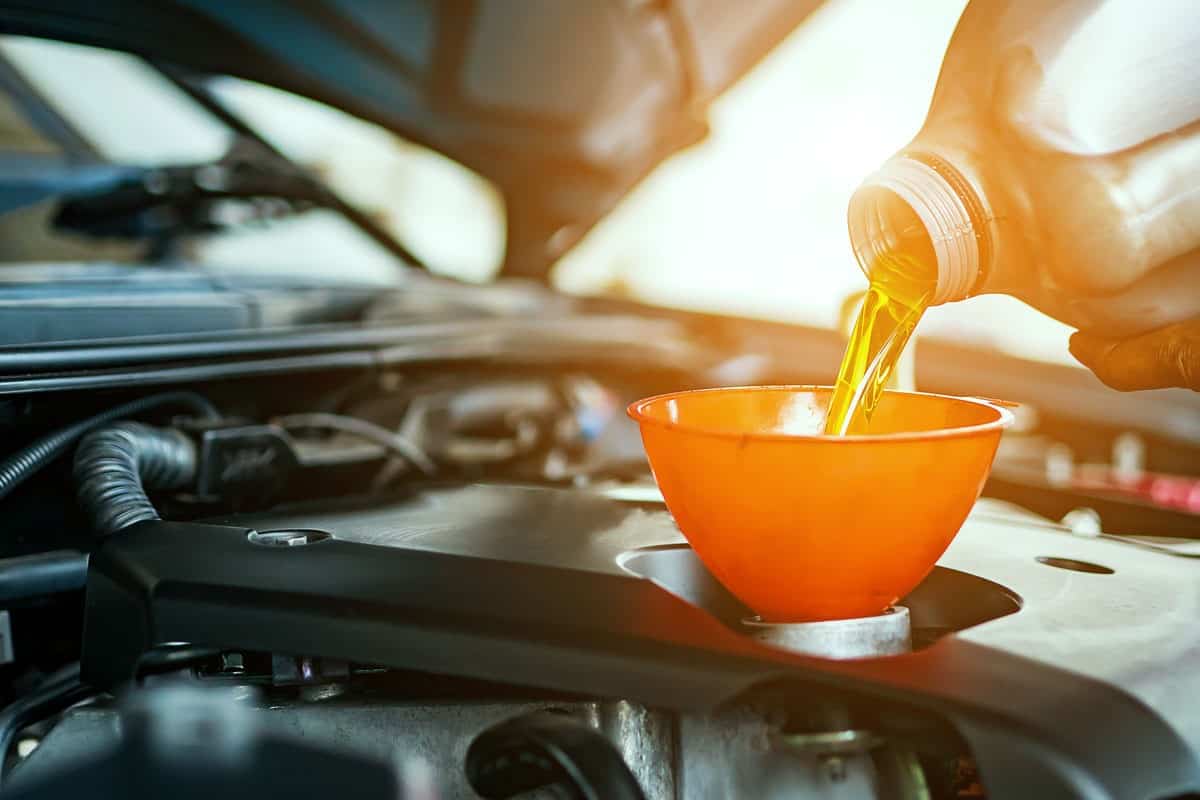 hand mechanic repairing car change oil