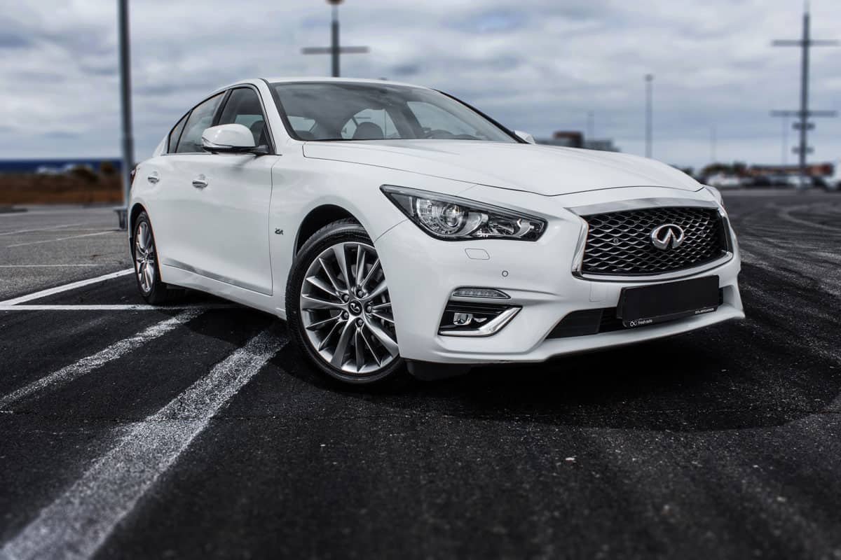 infiniti q50 white color parking on the parking lot outdoor,