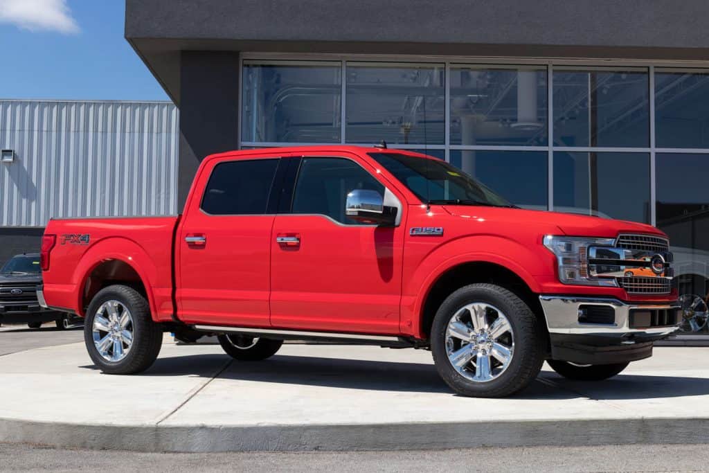A huge red Ford F150 FX4 truck at the dealership