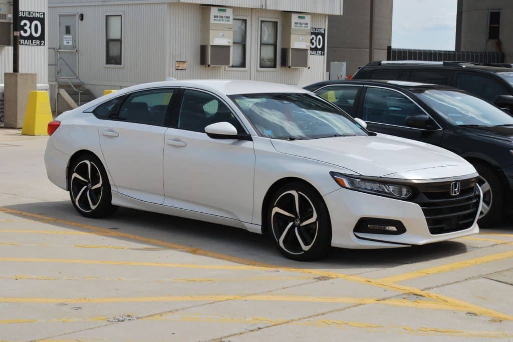 A white Honda Accord photographed on the parking lot