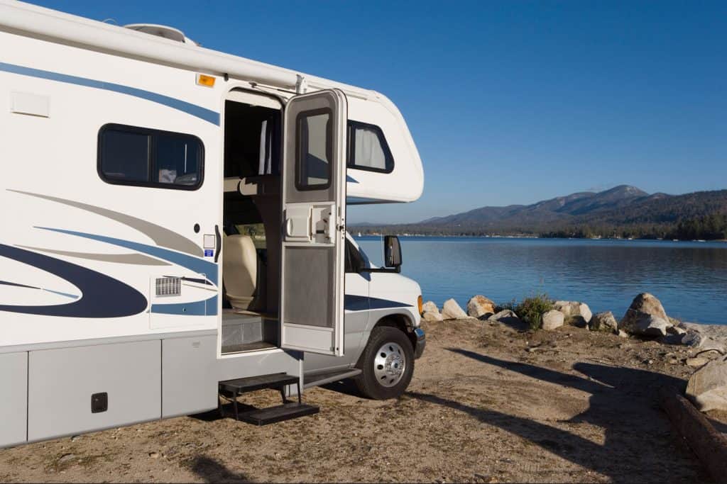 An RV parked near a lake with a gorgeous and breathtaking view