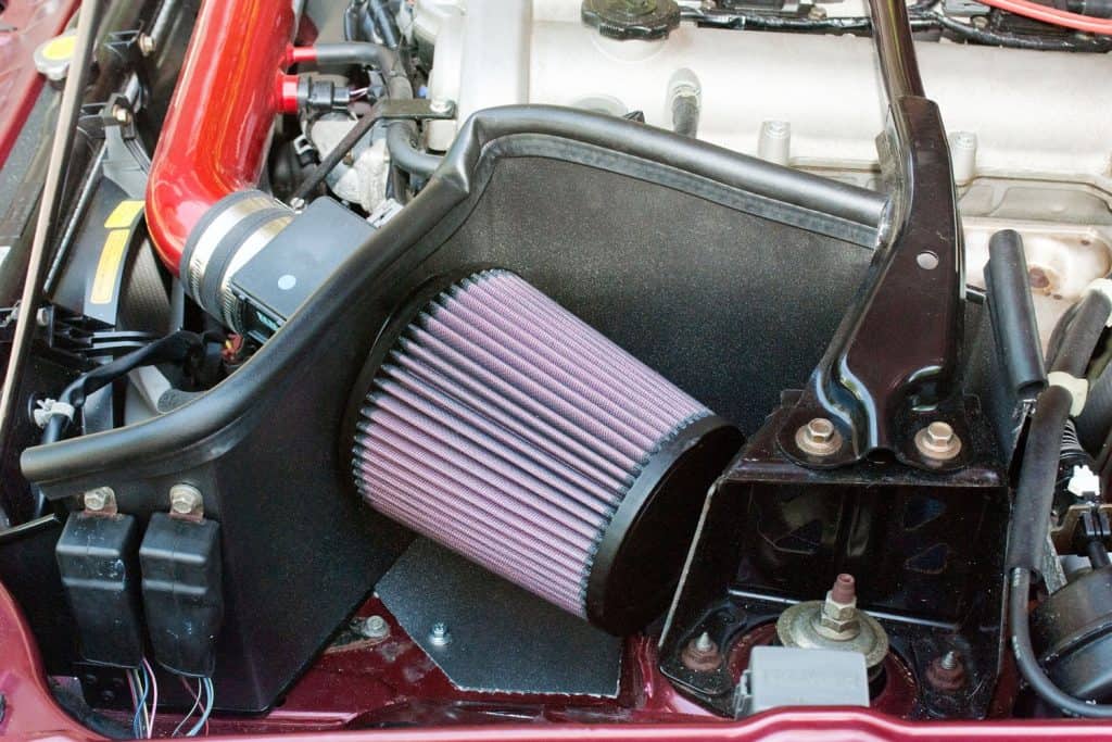 An open car air filter in an open car engine