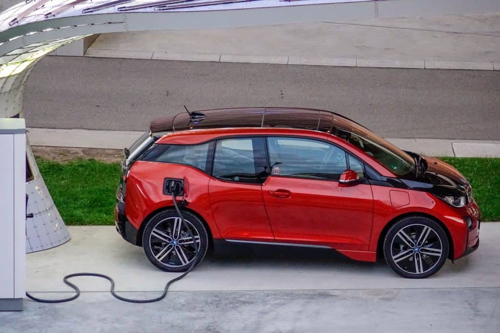 Electric car BMW I3 charging its batteries on a parking, Why Do Some Cars Have Black Roofs?