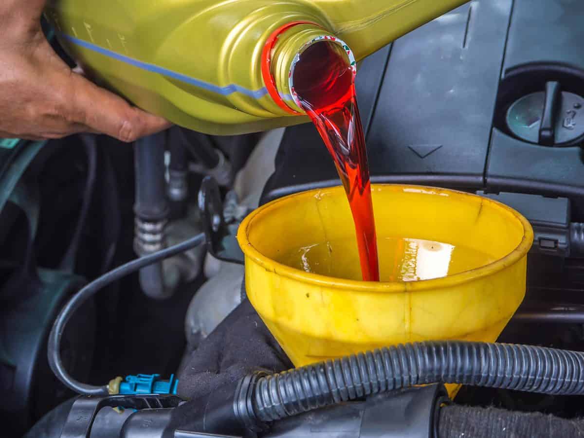 Hand fill up in a car engine with transmission oil