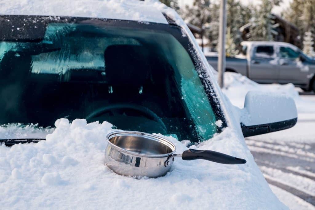 Hot water in pot to solve ice problem on car window