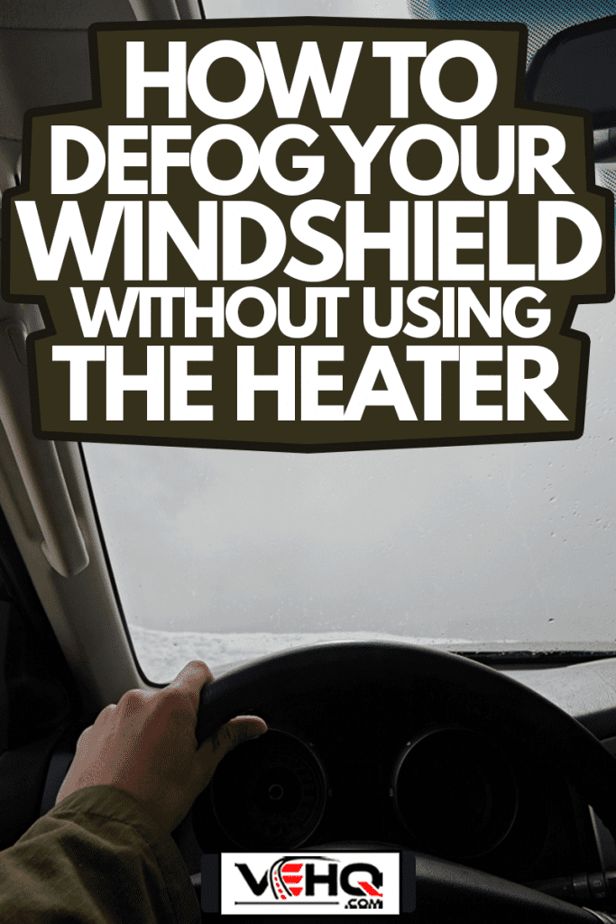 Close-up of the hands of the driver on the steering wheel of a car with fogged windshield, How To Defog Your Windshield Without Using The Heater