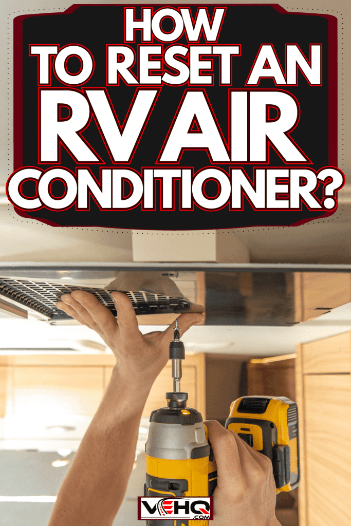 A worker installing an air conditioning unit inside an RV, How To Reset An RV Air Conditioner?