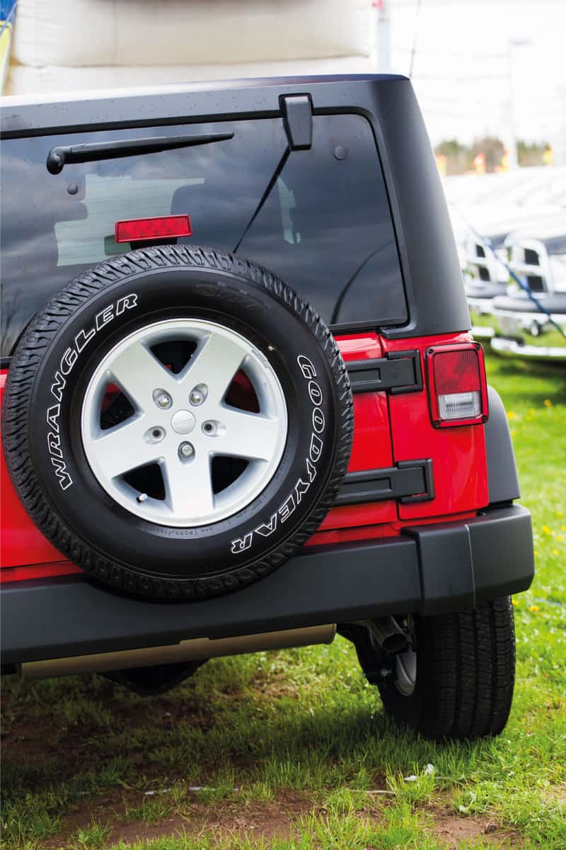 Jeep Wrangler Sport rear view parked on a grass surface