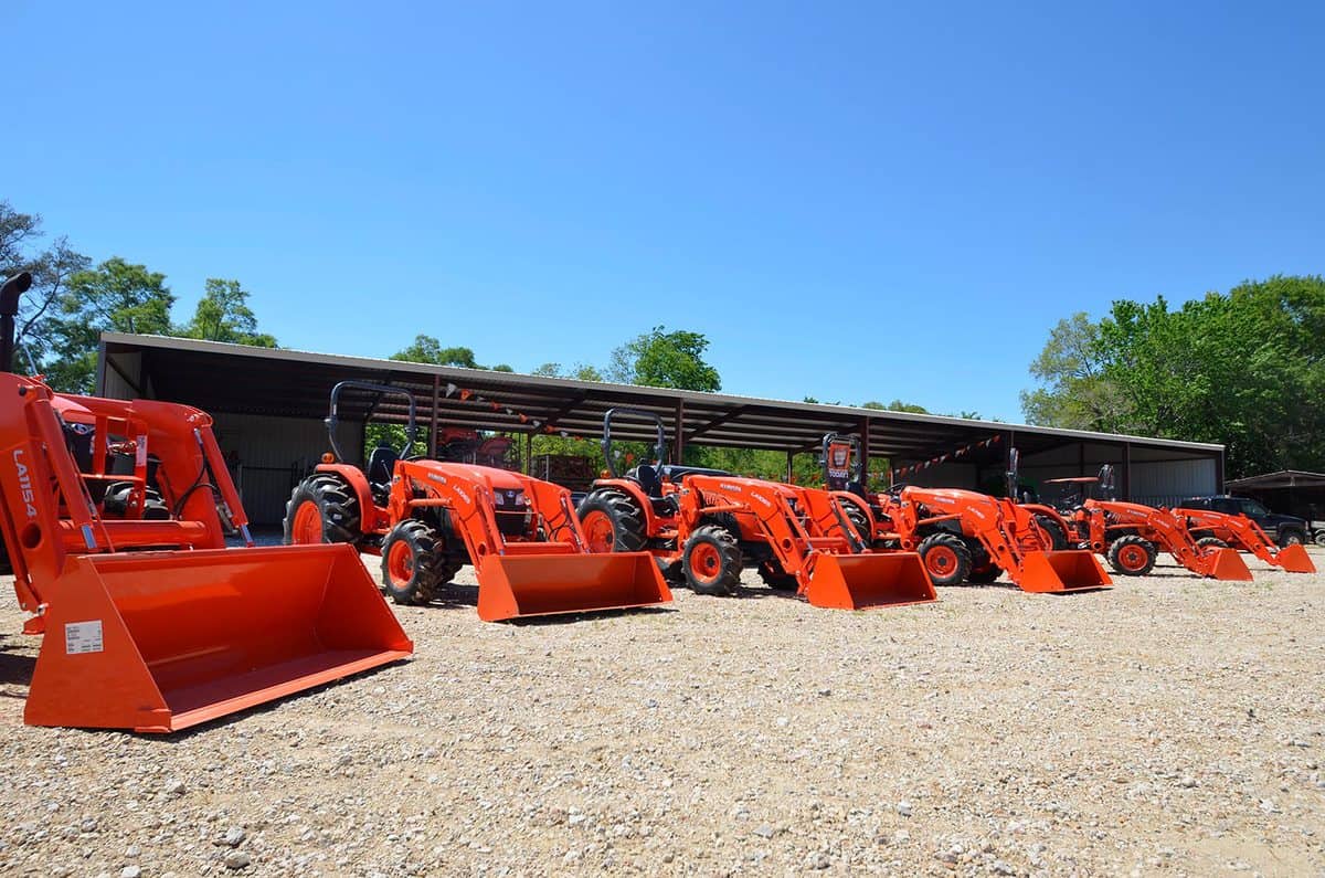 Line of orange Kubota tractors