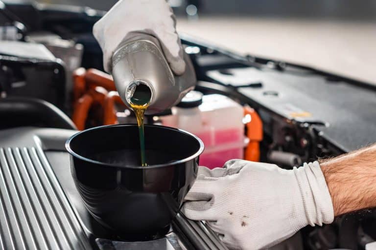 Mechanic pouring oil to car engine, What Happens If You Put Water In Your Car Oil?