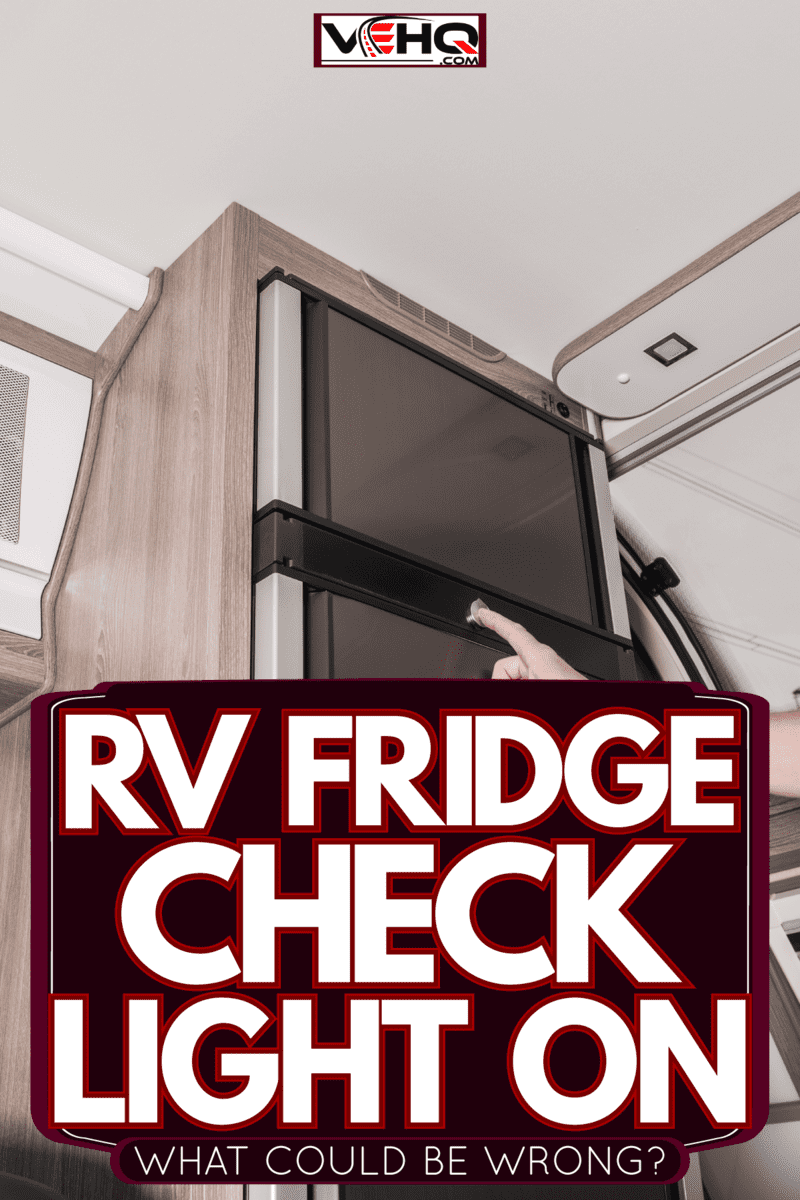 A repairman checking the RV fridge, RV Fridge Check Light On - What Could Be Wrong? dometic rv fridge check light