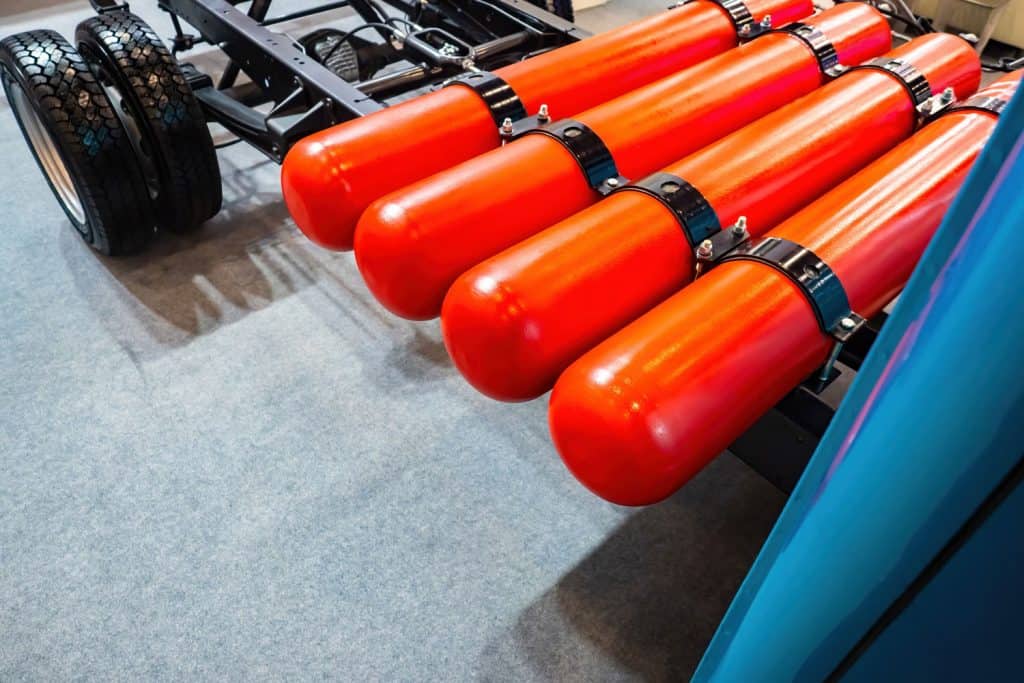 Red gas cylinders for transport. Vehicle runs on liquefied gas