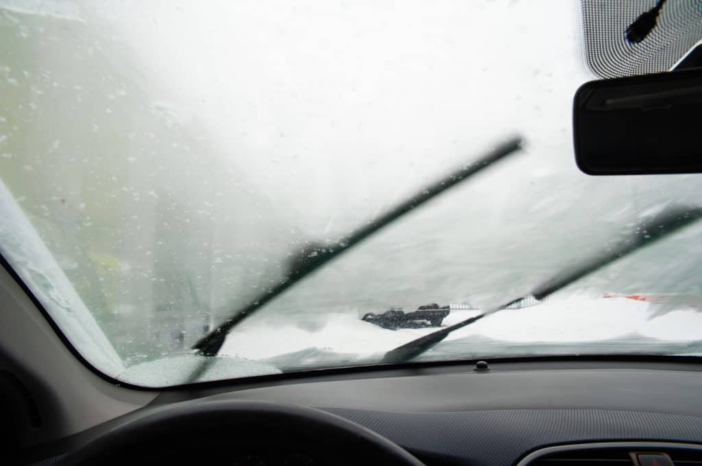 Whipers are pushing snow away form the steamy windshield