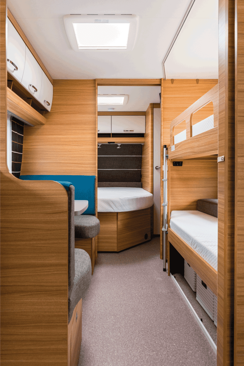 bunk bed area in a recreational vehicle with wood accent