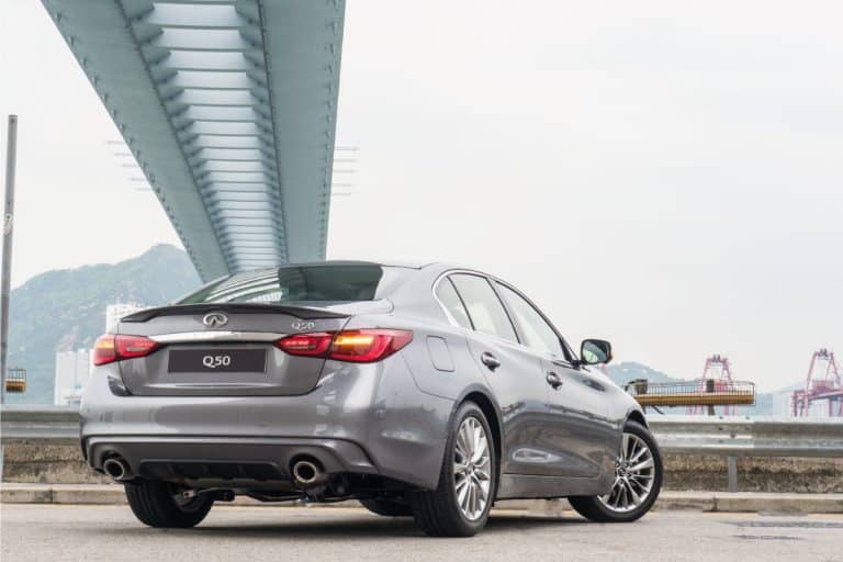 rear view of a silver colored Infiniti Q50 parked under a bridge. Does Infiniti Q50 Have Paddle Shifters
