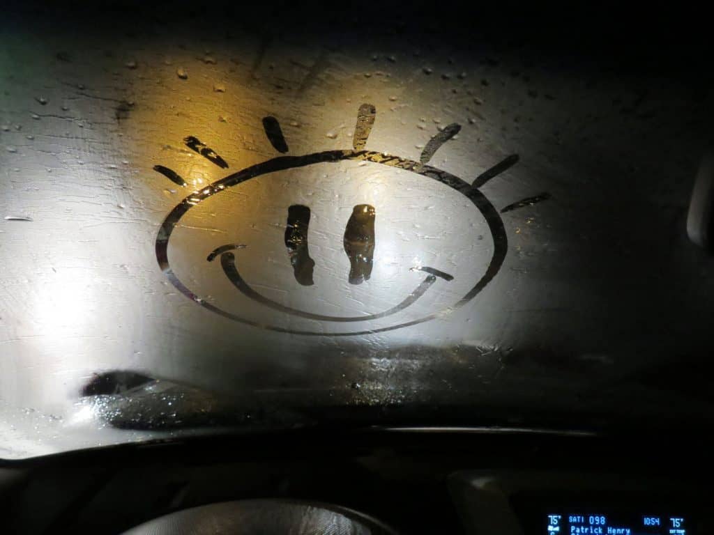 smiley face on foggy windshield