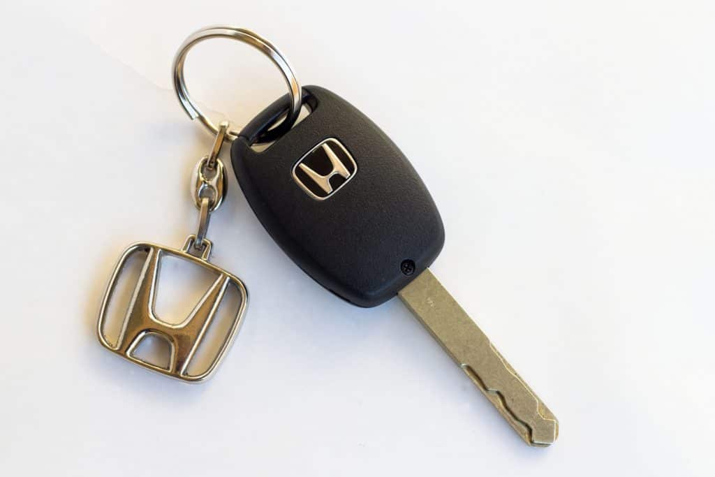 A Honda Car key on a white background
