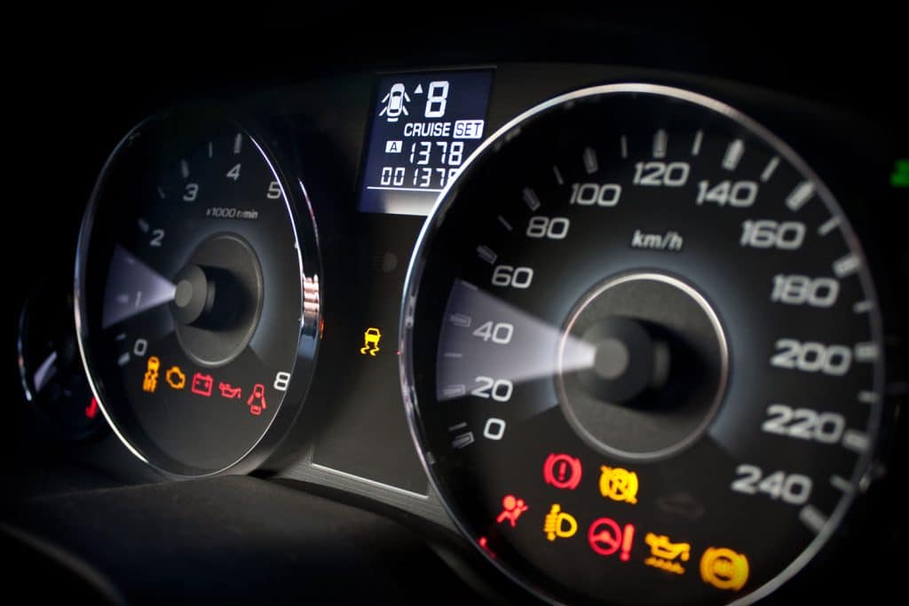 A car dashboard with all the lights of the car dashboard on