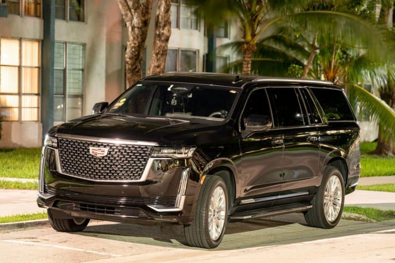 A huge black colored Cadillac Escalade parked on the side of the street, How To Open A Cadillac Escalade With A Dead Battery