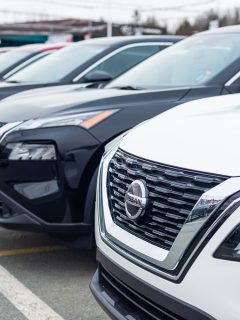 A line up of Nissan Rogue with different colors at a dealership, How Far Can A Nissan Rogue Go On Empty?