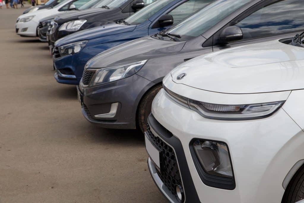 A line up of Kia vehicles at a dealership