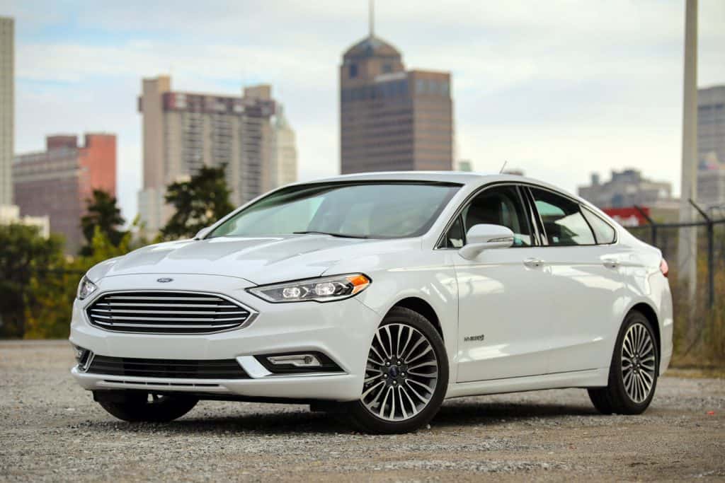 A sleek and white Ford Fusion photographed on a park