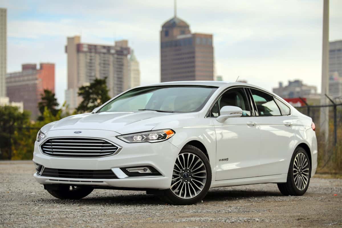 A sleek and white Ford Fusion photographed on a park, How To Unlock Ford Fusion With Keys Locked Inside