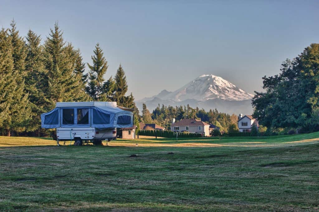 A tent camper set up on the camping ground for a scenic view of Mt Rainier