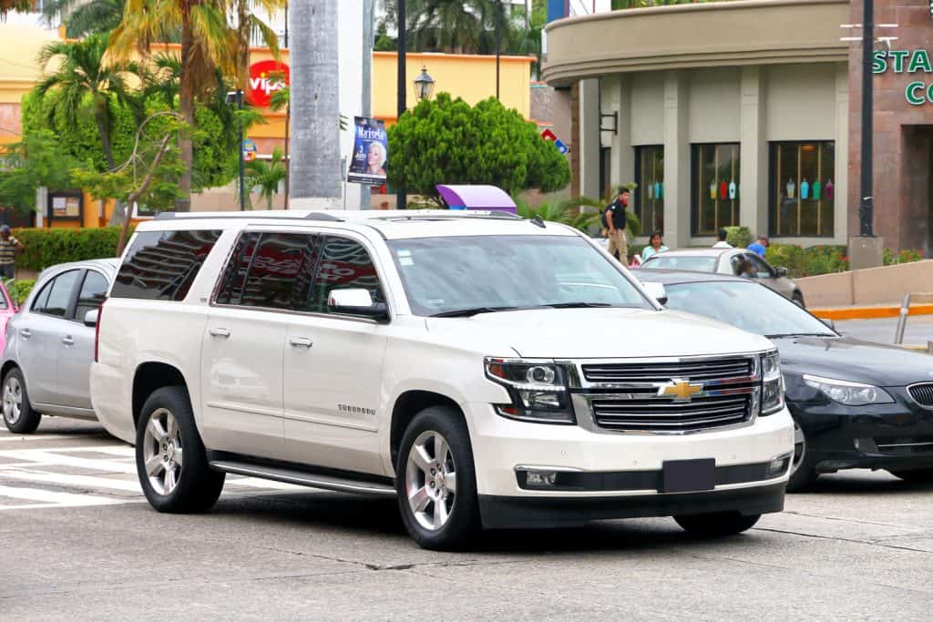 A white Chevrolet Suburban moving along the highway