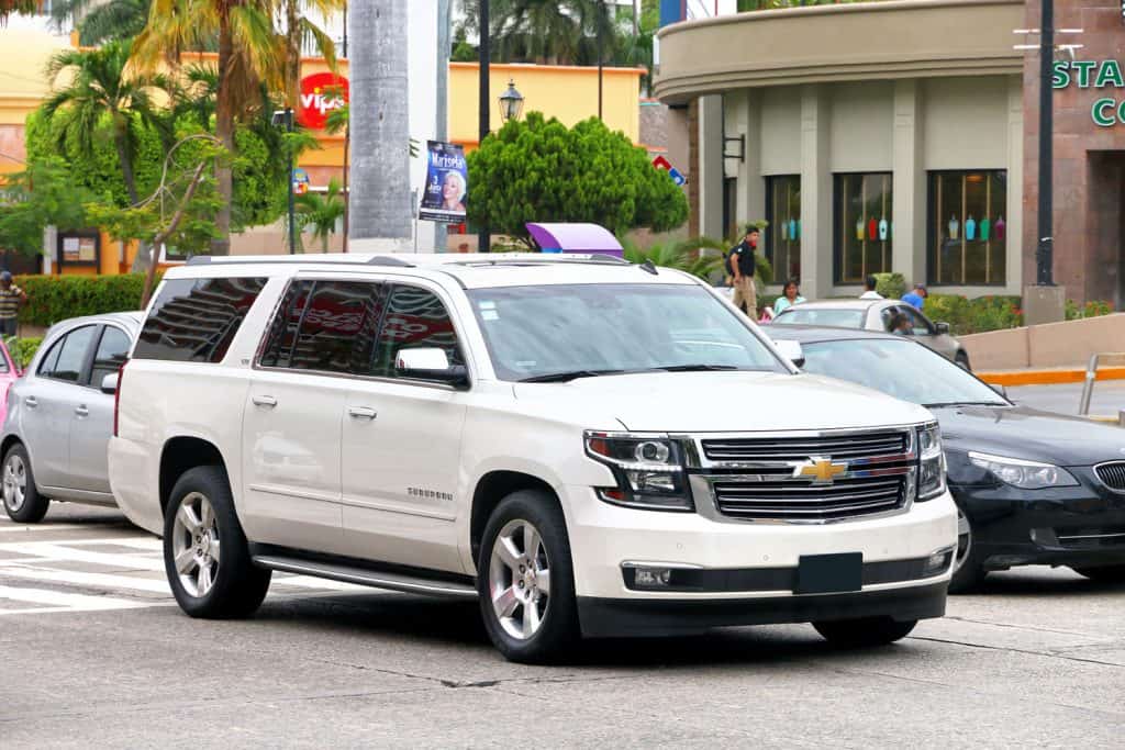 A white Chevrolet Suburban photographed on the parking lot