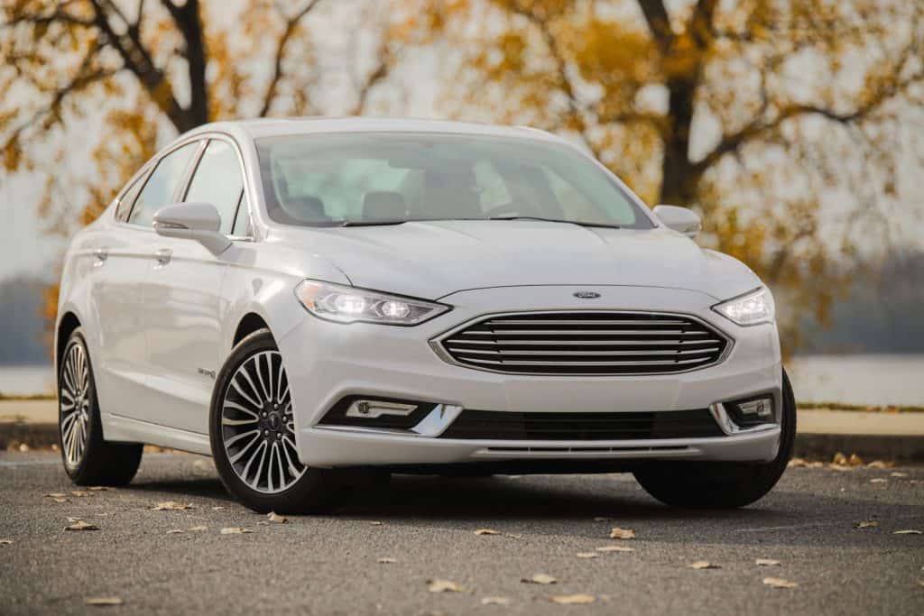 A white Ford Fusion photographed at a parking lot