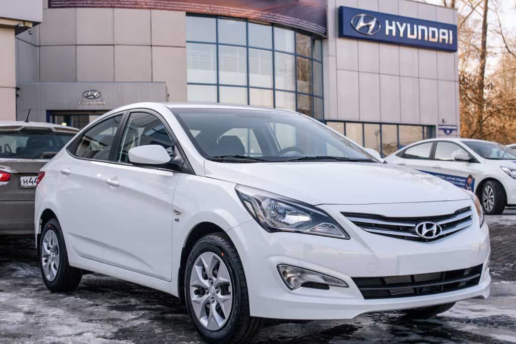 A white Hyundai Accent displayed at a Hyundai dealership