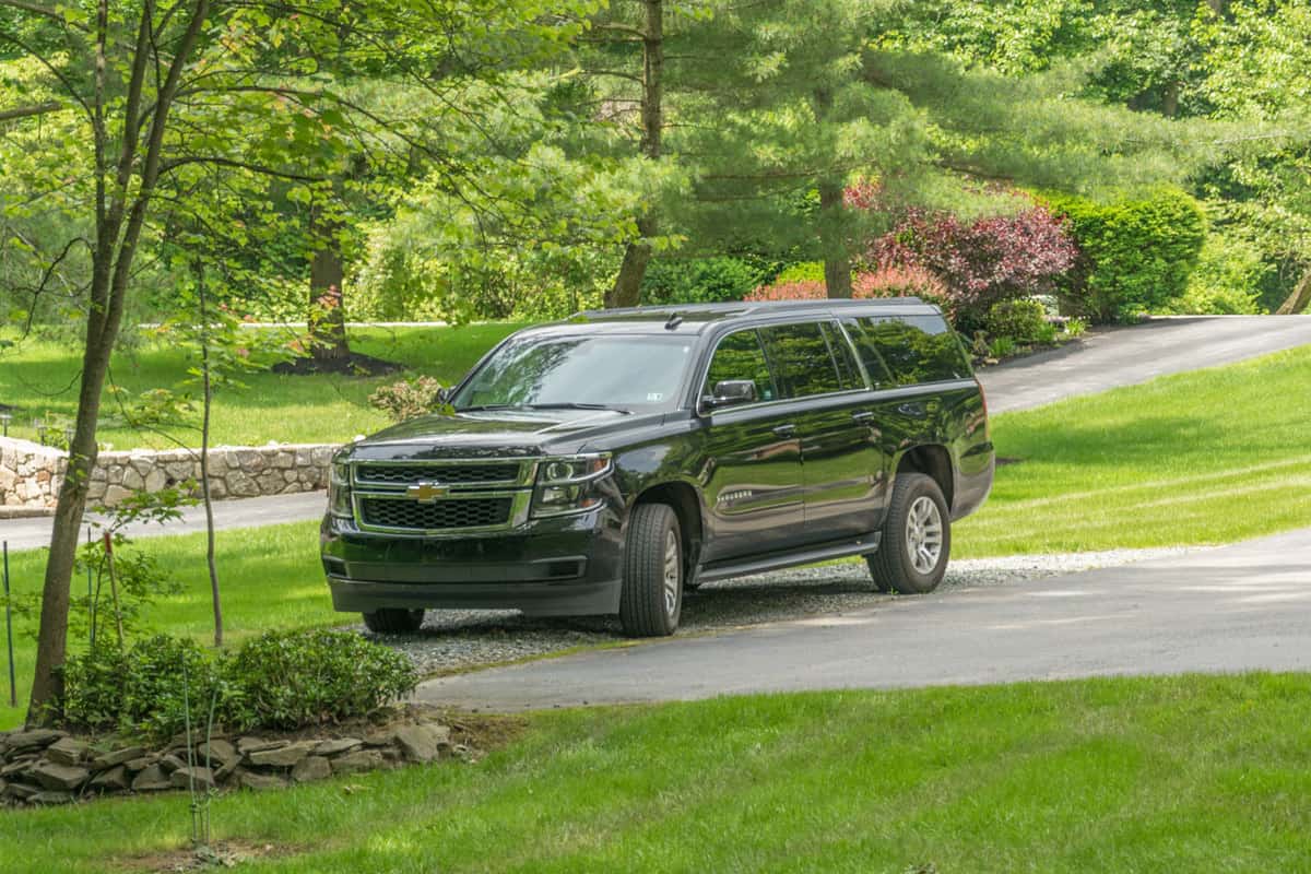 Black Chevrolet Suburban parked in driveway - United States of America, Can You Flat Tow a Suburban?