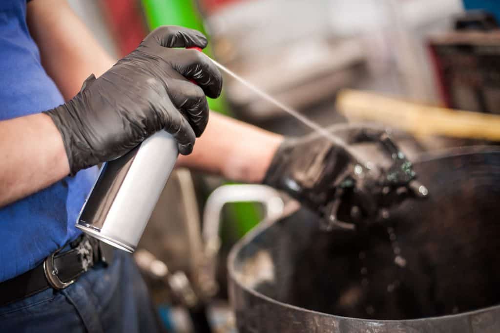 Car master mechanic repairer lubricates the screws