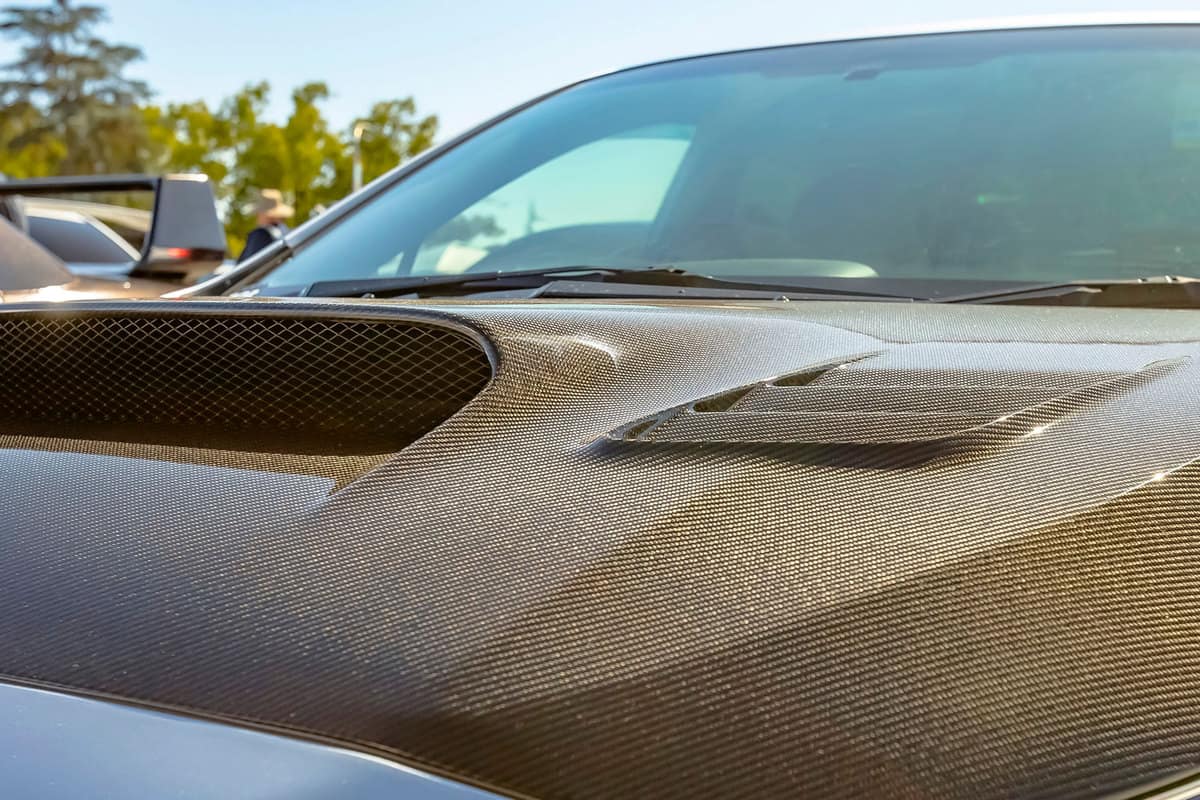 Carbon fiber hood of a silver car on a sunny day, How To Paint A Carbon Fiber Hood?