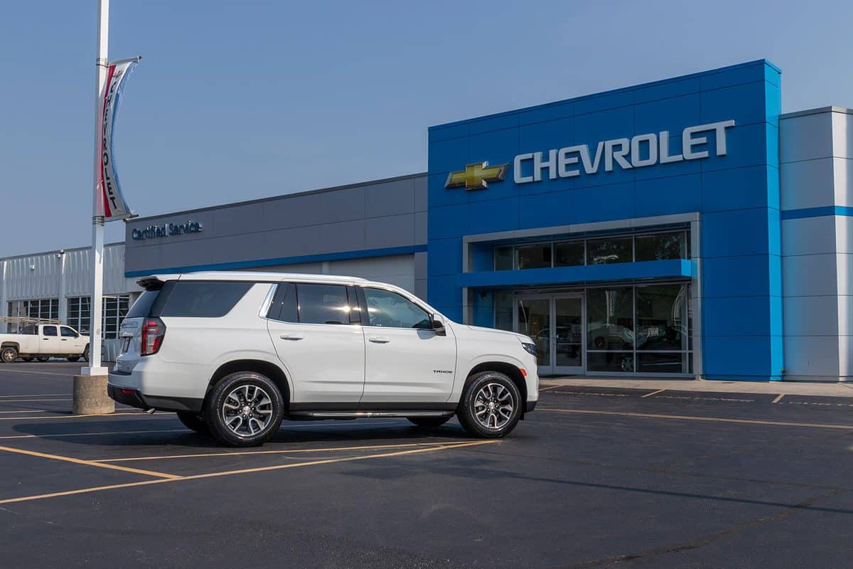 Chevrolet Tahoe SUV parked in front of CHEVROLET store
