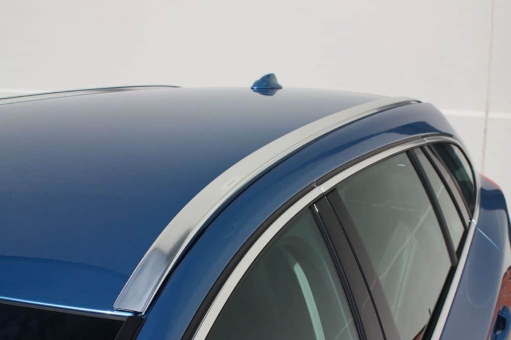 Chrome roof rail trim on a modern blue vehicle