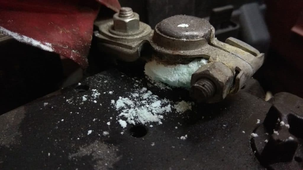 Close up of a car batter terminal that is corroded.