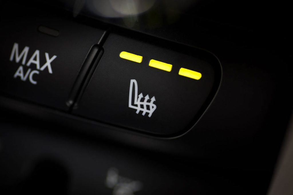 Detail of the heated seats button in a car.