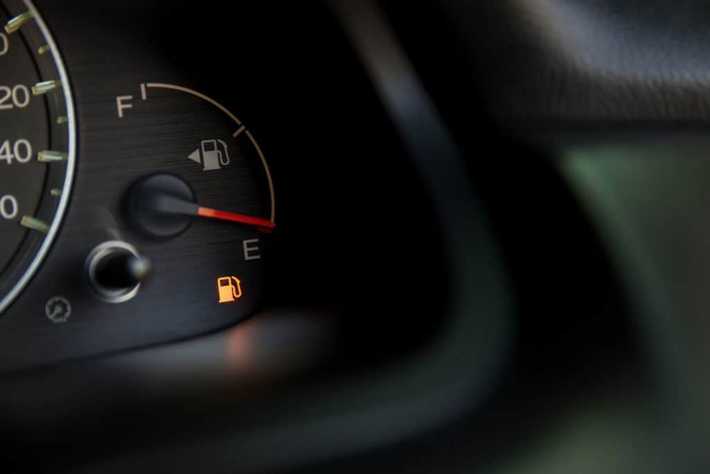 Empty fuel warning light in car dashboard.