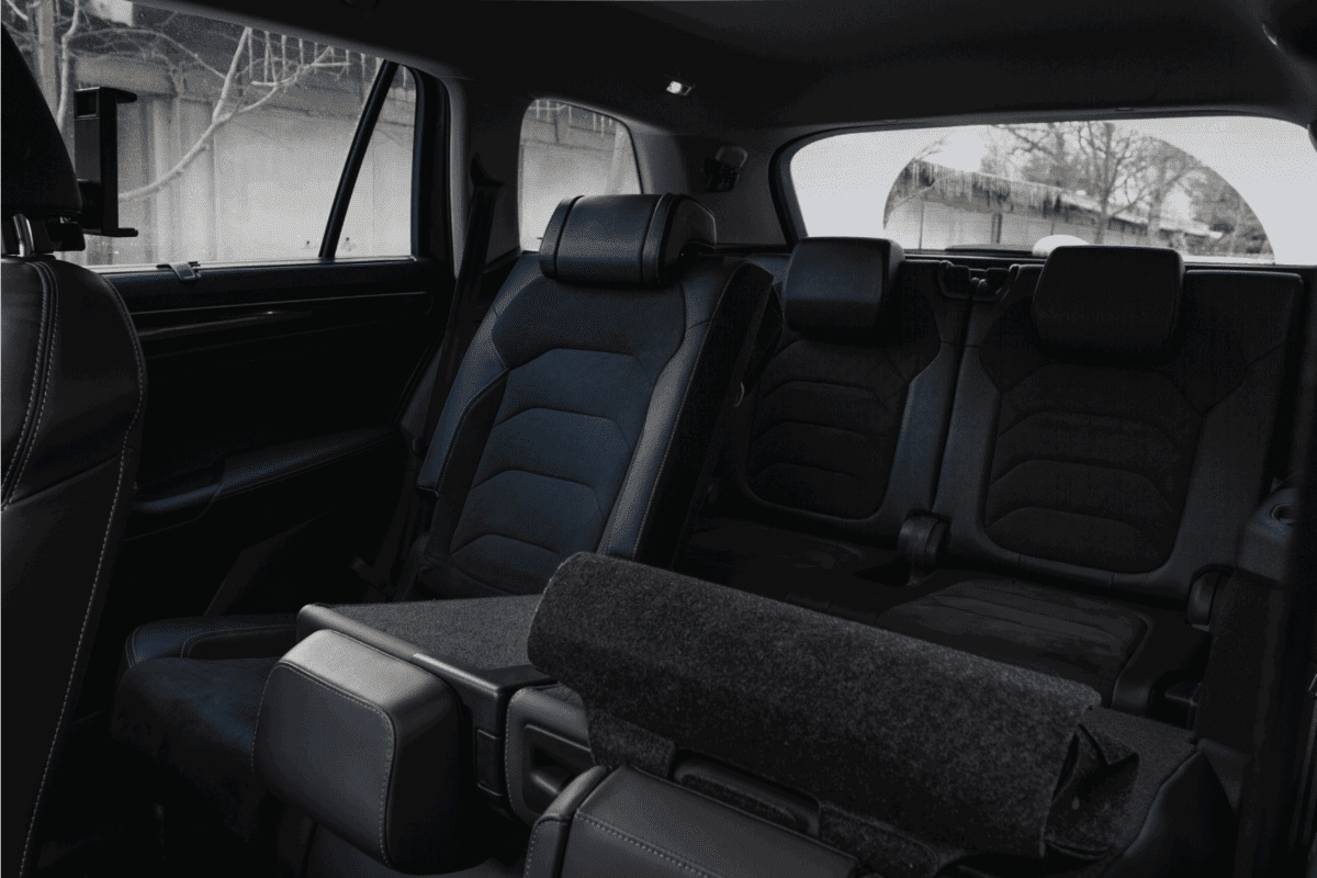 Folding seats and a cargo space inside suv car. Modern car interior. Huge, clean and empty car trunk.