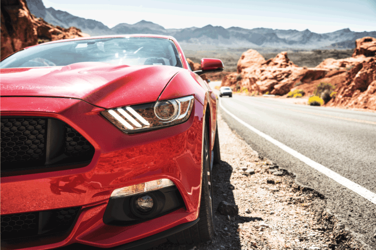 Front view of a red Ford Mustang GT parked along the road of the Valley. How To Bypass The PATS System Ford Mustang