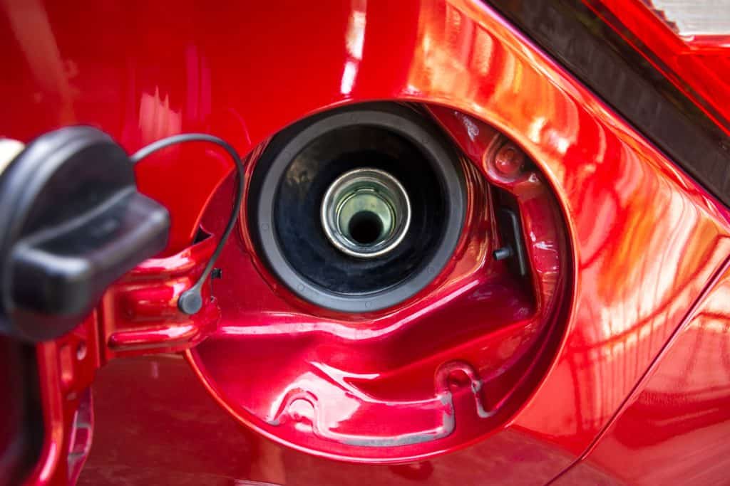 Fuel tank cap of the red car is open